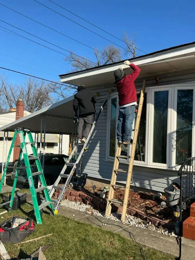 Restoration crew performing exterior repair in Lansing